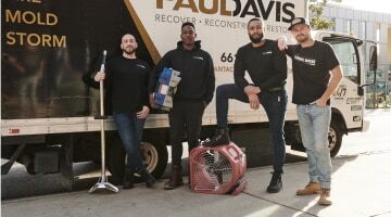 Paul Davis Restoration of South Orange County team members standing with restoration equipment beside a company truck